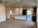 Open concept kitchen with island and laundry access at 4306 Sagefield Dr, Harmony, FL 34773