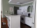 Bright kitchen features white cabinets, a breakfast bar, and modern appliances at 4113 Enchanted Oaks Cir # 1216, Kissimmee, FL 34741