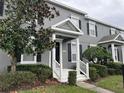 Gray townhome exterior with white columns and landscaping at 14460 Clarkson Dr, Orlando, FL 32828