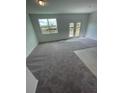 Spacious living room with carpet and sliding doors at 153 Mandovi St, Davenport, FL 33837