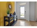 Bright and airy entryway with a stylish console table and mirror at 3337 Aruba Way, Haines City, FL 33844