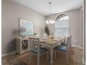 Bright dining room with wood table and blue chairs at 8747 Bridgeport Bay Cir, Mount Dora, FL 32757