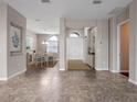 Spacious entryway with tile floors and views to dining area at 8747 Bridgeport Bay Cir, Mount Dora, FL 32757