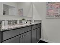 Bathroom with granite countertops and double sinks in grey cabinets at 3726 Bluethread Way, Poinciana, FL 34759