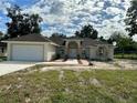 One-story home with attached garage, walkway, and landscaping at 17271 E Peggy Ave. Ave, Mount Dora, FL 32757