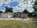 One-story house featuring a front yard and attached garage at 17271 E Peggy Ave. Ave, Mount Dora, FL 32757
