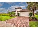 House exterior showcasing a brick paver driveway and lush landscaping at 3951 Carrick Bend Dr, Kissimmee, FL 34746