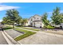 Two story house on a tree lined street with a paver driveway at 4782 Kings Castle Cir, Kissimmee, FL 34746