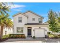 Two-story house with a white exterior and a two car garage at 4782 Kings Castle Cir, Kissimmee, FL 34746