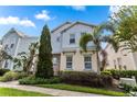 Two-story home with light blue siding and stone accents at 1407 Fairview Cir, Reunion, FL 34747