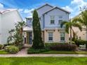 Two-story home with light blue siding and stone accents at 1407 Fairview Cir, Reunion, FL 34747