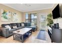 Spacious living room with sectional sofa and large TV at 909 Charo Pkwy # 1021, Davenport, FL 33897