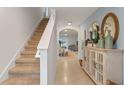 Light-filled foyer with staircase and decorative console table at 2571 Sage Valley Way, Winter Haven, FL 33884