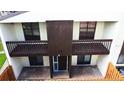 Front exterior view of a two-story condo unit with dual balconies at 2649 Crown Ct # 2649, Kissimmee, FL 34741