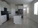 Open concept kitchen with island and stainless steel appliances at 3025 Ballad Rd, Kissimmee, FL 34746
