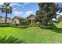 One-story home with stone accents and manicured hedges at 25822 Feather Ridge Ln, Sorrento, FL 32776