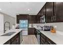 Modern kitchen with stainless steel appliances and white quartz countertops at 1069 River Otter Way, Deland, FL 32720