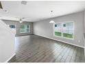 Open living room and dining area with gray tile flooring at 15116 Dragon Fly Ct, Winter Garden, FL 34787