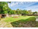 Spacious backyard with a gazebo, trampoline, and wooden fence at 488 Providence Blvd, Deltona, FL 32725