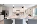 Kitchen island with seating for four and granite countertops at 2932 Waterlily Way, Poinciana, FL 34759