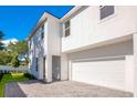 Modern two-story house with white exterior, paver driveway, and attached garage at 131 E Grant, Orlando, FL 32806