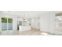 Open concept kitchen with white cabinets, quartz countertops, and stainless steel appliances at 131 E Grant, Orlando, FL 32806