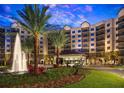 Apartment building with a fountain and lush landscaping at 14501 Grove Resort Ave # 1507, Winter Garden, FL 34787