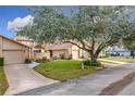 Front view of charming condo with spacious yard and mature tree at 564 Darby Way, Longwood, FL 32779