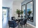 Modern dining area with glass table and four blue chairs at 1502 Isleta Loop, Kissimmee, FL 34741