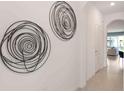 Elegant hallway featuring modern wall art and tile flooring at 1502 Isleta Loop, Kissimmee, FL 34741