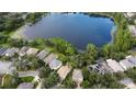 Community features a serene lake surrounded by lush trees and houses at 3329 Lake Jean Dr, Orlando, FL 32817