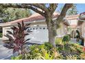 One-car garage with white door and landscaping at 1010 Winderley Pl # 139, Maitland, FL 32751