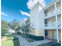 Condo building exterior with walkway and landscaping at 7505 Mourning Dove Cir # 302, Kissimmee, FL 34747