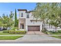 Two-story home with stone and stucco exterior and two-car garage at 8461 Via Vittoria Way, Orlando, FL 32819