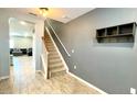 Bright entryway with tile flooring, stairs, and a coat rack at 301 Primrose Dr, Davenport, FL 33837