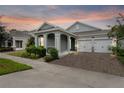 Attractive home with two-car garage, at dusk at 890 Terrapin Dr, Debary, FL 32713