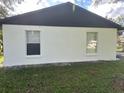 Side view of the house showcasing freshly painted walls at 641 Bayport Dr, Kissimmee, FL 34758