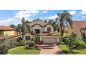 Two-story house with a brick driveway and nicely landscaped lawn at 212 Crestrun Loop, Leesburg, FL 34748
