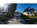 House exterior with a two-car garage and landscaping at 2939 Falling Tree Cir, Orlando, FL 32837