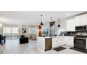 Open concept kitchen with modern appliances, island, and breakfast bar at 4625 Target Blvd, Kissimmee, FL 34746