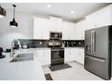 Modern kitchen with stainless steel appliances and white shaker cabinets at 4625 Target Blvd, Kissimmee, FL 34746