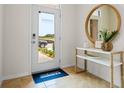 Front entry with a modern door and console table; view of the driveway beyond at 2224 Tongass Bnd, Davenport, FL 33837