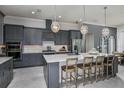 Modern kitchen with large island and stainless steel appliances at 1604 Evening Summit Cir, Minneola, FL 34715