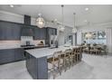 Modern kitchen with large island and stainless steel appliances at 1604 Evening Summit Cir, Minneola, FL 34715