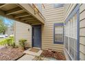 Condo unit entry with private patio and blue door at 938 Framlingham Ct # 102, Lake Mary, FL 32746