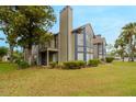 Tan two-story condo building with blue trim, balconies, and landscaping at 938 Framlingham Ct # 102, Lake Mary, FL 32746