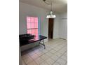 Bright dining area with tile floor and a foldable table at 305 Erie Ct, Kissimmee, FL 34759