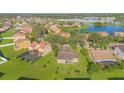 Aerial view of houses and a lake in a residential community at 3070 Silver Fin Way, Kissimmee, FL 34746