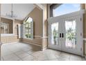 Elegant entryway with stained-glass doors and tile flooring at 2128 Lake Crescent Ct, Windermere, FL 34786
