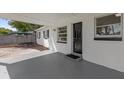 Covered porch entrance with gray flooring and black door at 4515 Dutton Dr, Orlando, FL 32808